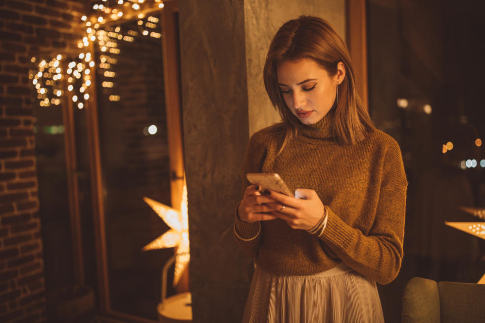 People feel alone on new year party, they standing out from the crowd and using mobile phone