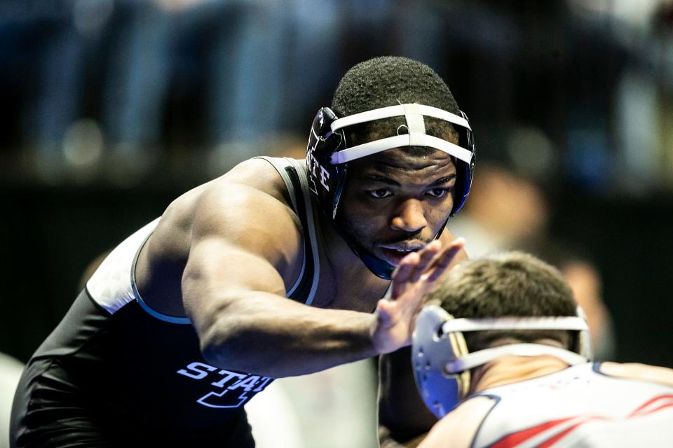 Iowa State's Paniro Johnson, left, wrestles Pennsylvania's Doug Zaph at 149 pounds during the third session of the NCAA Division I Wrestling Championships, Friday, March 17, 2023, at BOK Center in Tulsa, Okla.