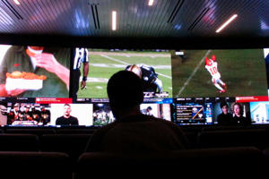 In this Nov. 20, 2018 photo, a customer watches video screens at a sportsbook in Atlantic City, N.J. (AP Photo/Wayne Parry)