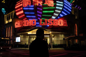 Pedestrians walking past Casino Lisboa in Macau, Oct. 20. Eduardo Leal—AFP/Getty Images