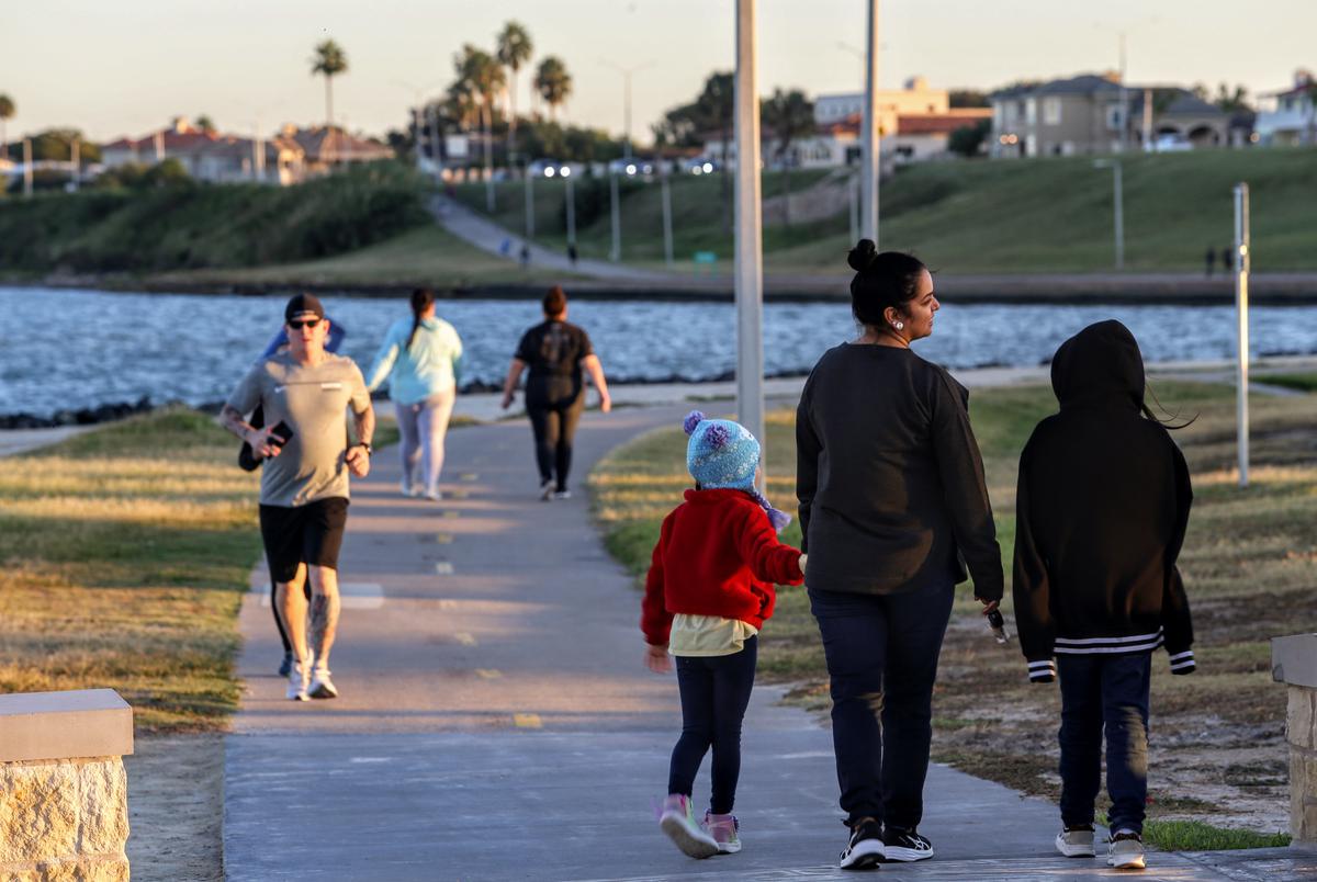 People of Corpus Christi stroll a bayside footpath at Cole Park.