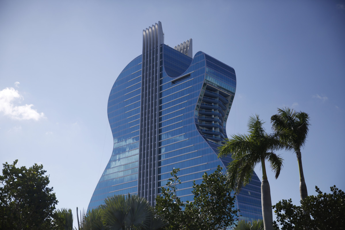 The guitar-shaped hotel is seen at the Seminole Hard Rock Hotel and Casino on Thursday, Oct. 24, 2019, in Hollywood, Florida. The Guitar Hotel's grand opening is on the tribe's land in Hollywood. It's the latest step in the Seminole Hard Rock empire, which includes naming rights on the Miami-area stadium where the 2020 Super Bowl will be played. (AP Photo/Brynn Anderson)