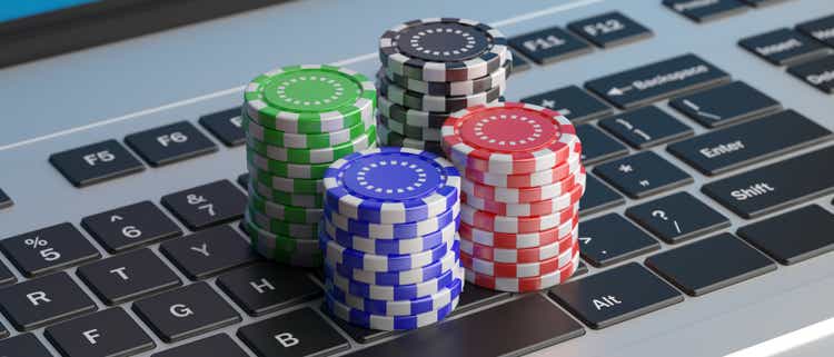 Casino poker chips stacks on a laptop keyboard. 3d illustration