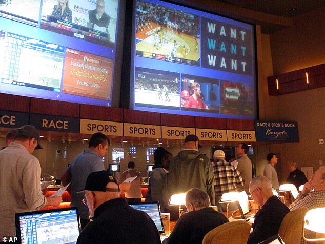 Gamblers line up to place bets on the NCAA men's college basketball tournament at the Borgata casino in Atlantic City, New Jersey