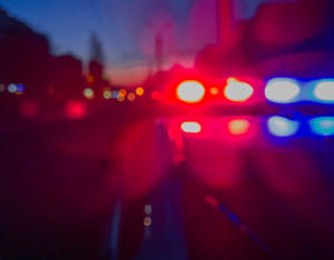 Red and blue Lights of police car in night time. Night patrolling the city. Abstract blurry image.