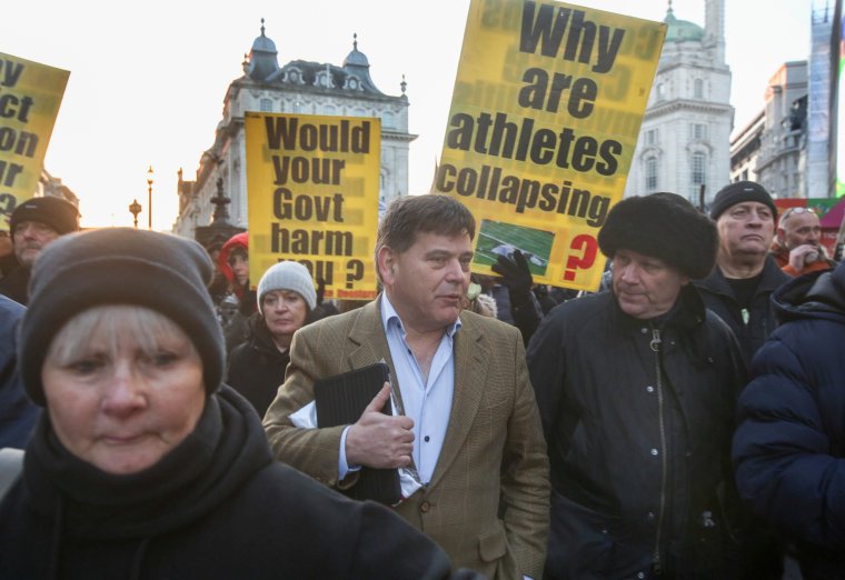 LONDON, UNITED KINGDOM - 2000/01/01: Former Conservative MP Andrew Bridgen joins the procession to Downing Street, while supporters hold boards and signs warning of the dangers of the vaccine. Hundreds from the freedom movement attended to offer support and listen to moving first-hand accounts of lives and health ruined following covid-19 vaccination. A silent procession led by some of the injured in wheelchairs went to Downing Street where hundreds of white roses were thrown over the gates. (Photo by Martin pope/SOPA Images/LightRocket via Getty Images)