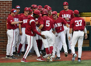 Alabama hitter Ed Johnson (5) is congratulated by teammates after he hit a home run against Samford at Sewell-Thomas Stadium Tuesday April 25, 2023.