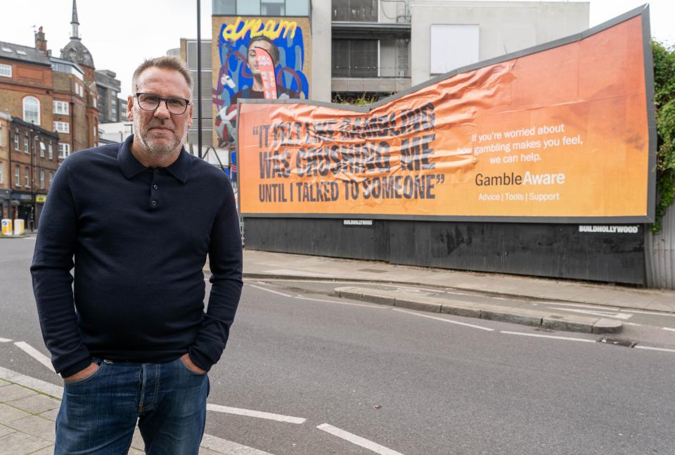  Paul Merson in front of a new GambleAware billboard 