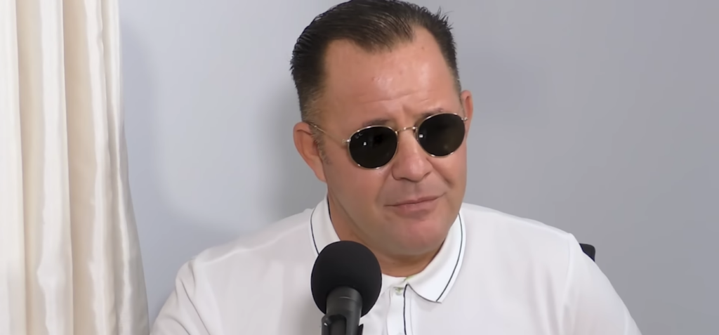 Jason Haddigan wearing sunglasses being interviewed on a youtube channel