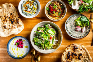 Complimentary lavash served fresh from a stone oven joins an array of dips and spreads at Joon.