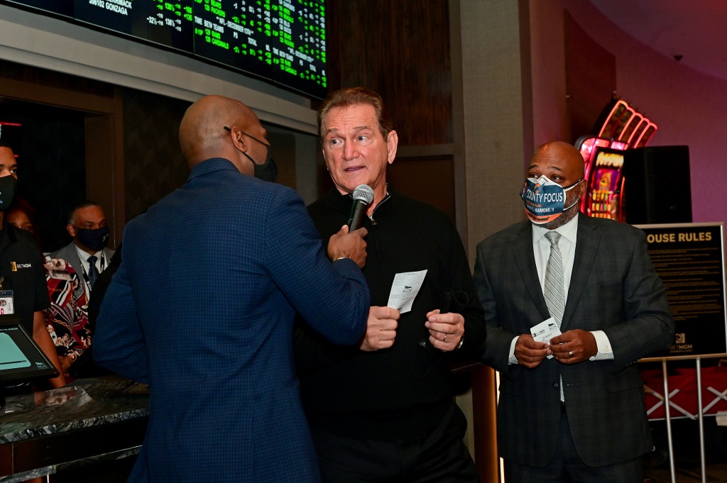 Joe Theismann (C) and Prince George's County Council Chairman Calvin S. Hawkins II speak to press as MGM National Harbor, Governor Larry Hogan and Joe Theismann launch sports betting in Maryland