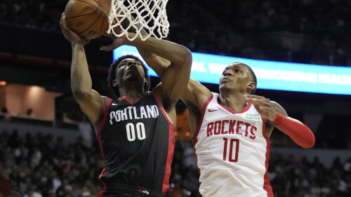 Houston Rockets' Jabari Smith Jr., right, fouls Portland Trail Blazers' Scoot Henderson during the second half of an NBA summer league basketball game Friday, July 7, 2023, in Las Vegas. (AP Photo/John Locher)