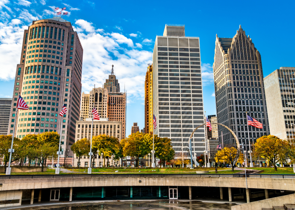 Tall buildings with American flags in front in Detroit.