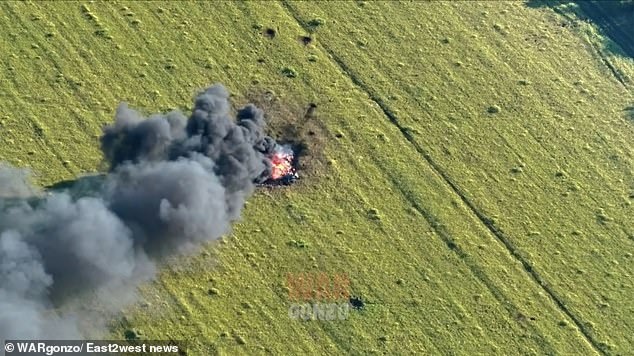 A new video shows the aircraft ablaze in a field with black smoke billowing into the sky. A helicopter lands close to the wreckage, and appears to inspect the damage before flying off