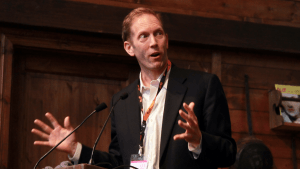 Henry Blodget of Business Insider gestures with both hands as he speaks.