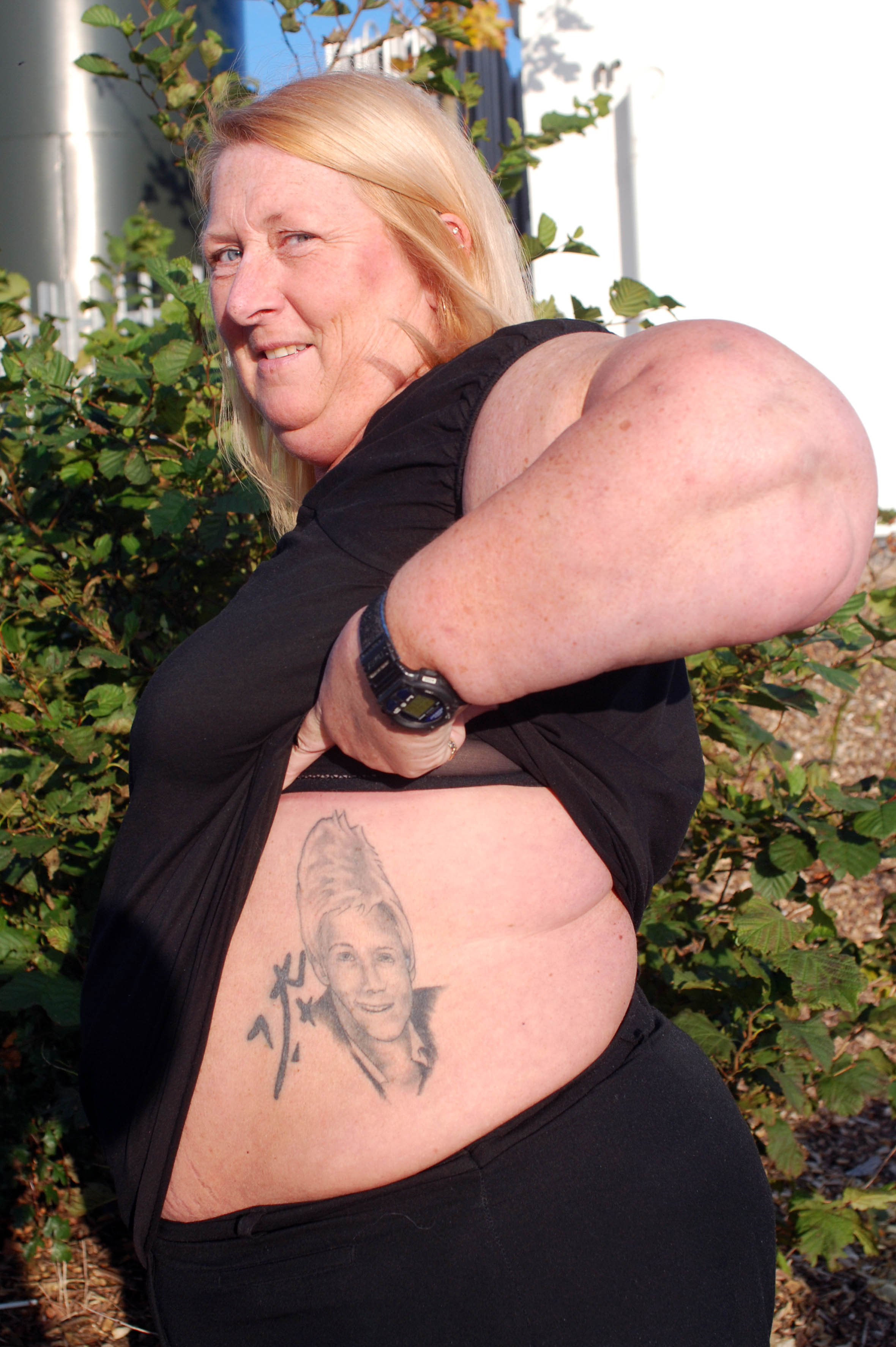 Fan Kathy Kennedy shows off her tattoo of Jonathan