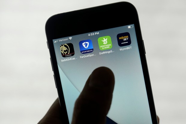 FanDuel, DraftKings and other mobile gambling apps are displayed on a phone. Former State Rep. David Nangle is warning against proposed cuts to programs that help fight gambling addiction. (AP Photo/Jeff Chiu, File)