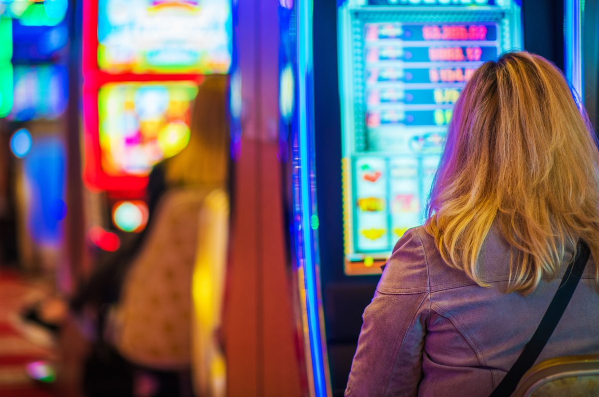 woman playing poker machine