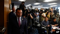 U.S. Attorney Martin Estrada, left, arrives for a news conference where he announced charges against the former longtime interpreter for Los Angeles Dodgers star Shohei Ohtani during a news conference in Los Angeles, April 11, 2024.