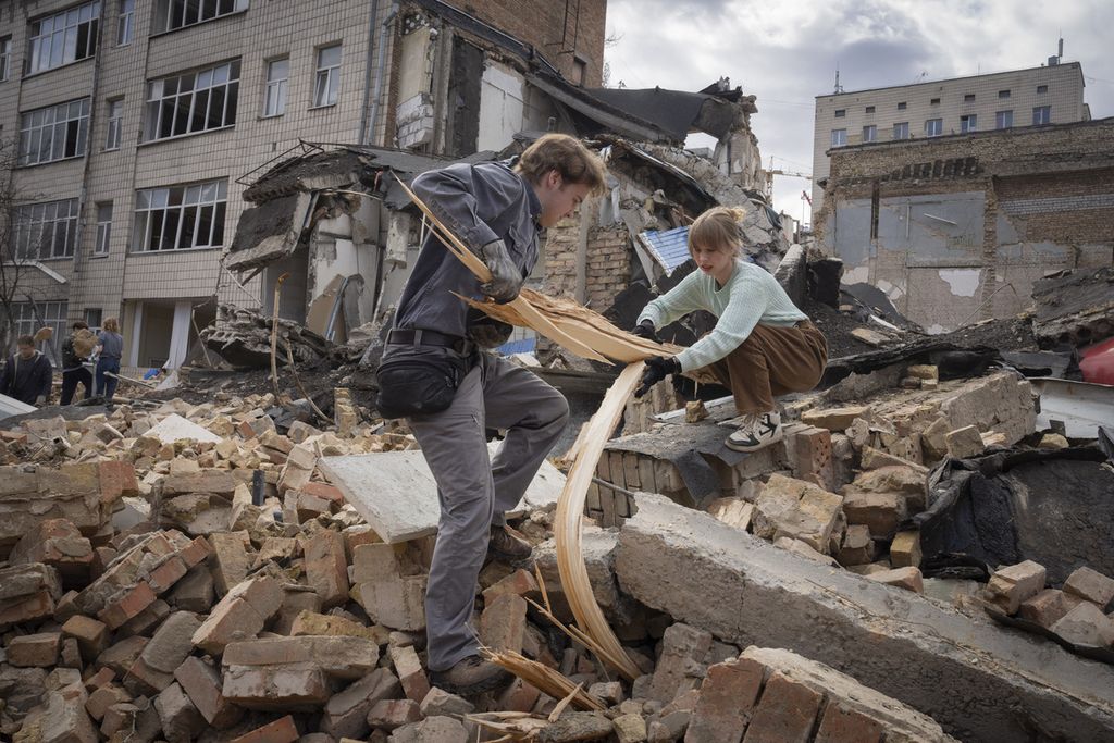 Cleaning up the aftermath of a Russian attack on the Kyiv State Arts Academy in Kyiv, Ukraine, March 30, 2024.