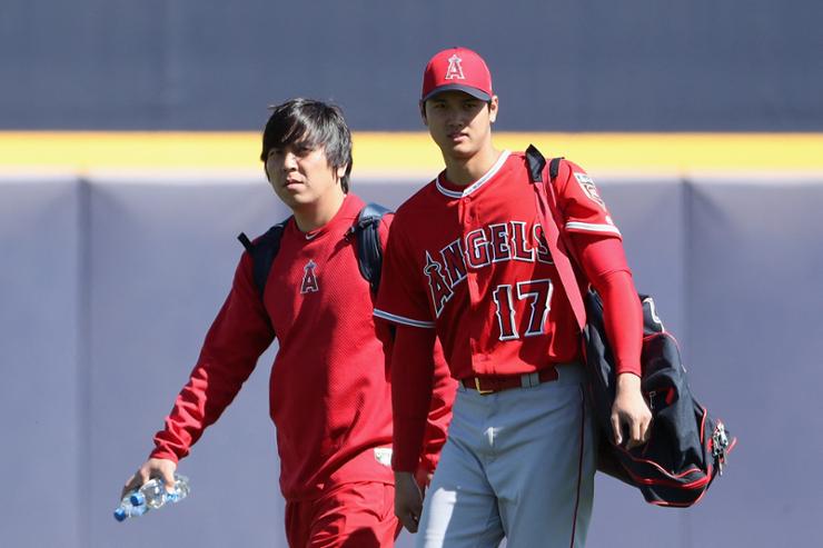 Shohei Ohtani, right, of the Los Angeles Angels arrives with his translator Ippei Mizuhara  to the spring training game against the San Diego Padres at Peoria Stadium on February 26, 2018 in Peoria, Arizona. Mizuhara was charged with bank fraud, April 11, for stealing more than $16 million from the Ohtani to pay gambling debts. AFP-Yonhap