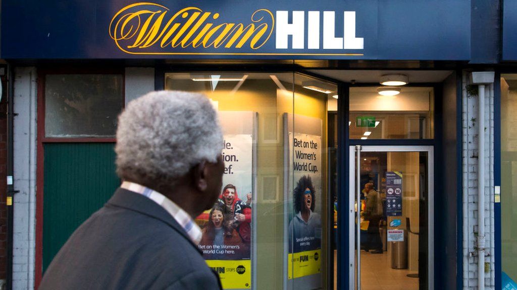 A man looks at a William Hill betting shop