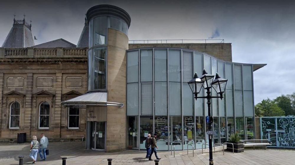 The outside of Sunderland Museum and Winter Gardens with people walking past