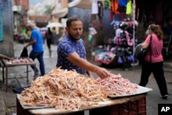 Jose Aldana, 39, sells chicken feet in the Petare neighborhood of Caracas, Venezuela, July 23, 2024.