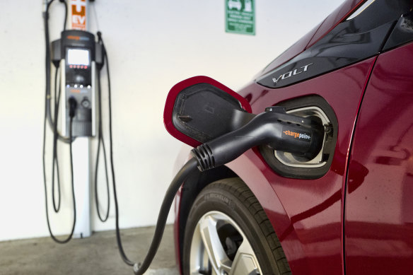 A hybrid car at a charging station.