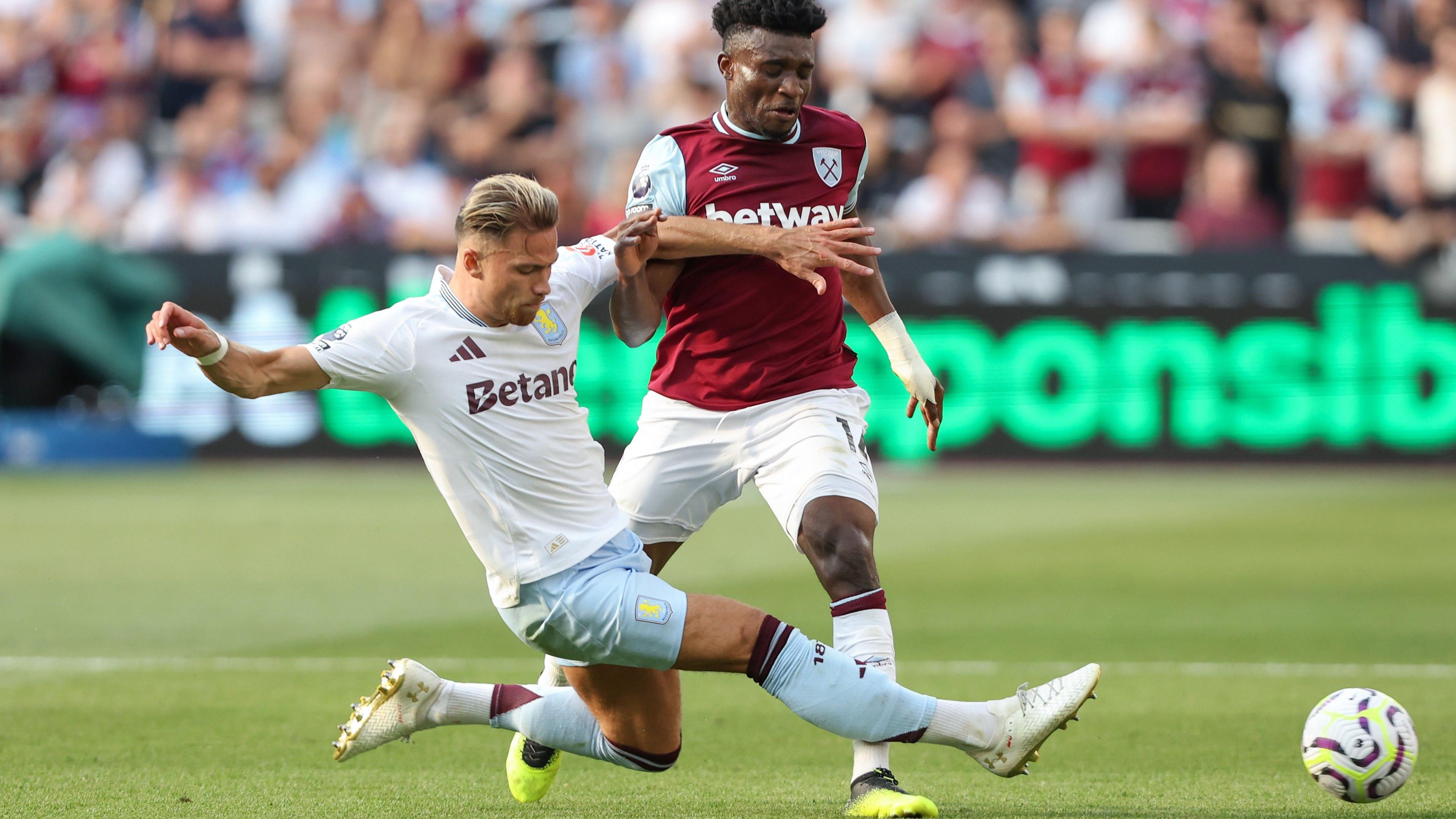 Aston Villa's Matty Cash slides in to tackle West Ham's Mohammed Kudus