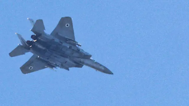 An Israeli Air Force F-15 Eagle fighter aircraft flies over Haifa on September 24