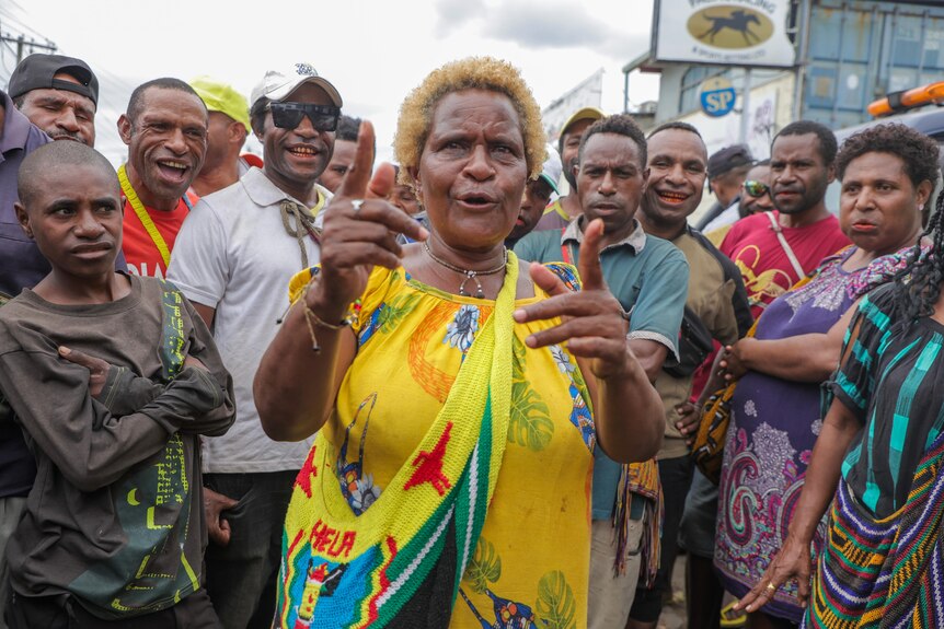 a woman wears yellow in a crowd