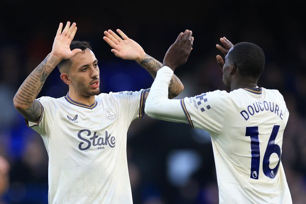 Dwight McNeil and Abdoulaye Doucoure of Everton embrace