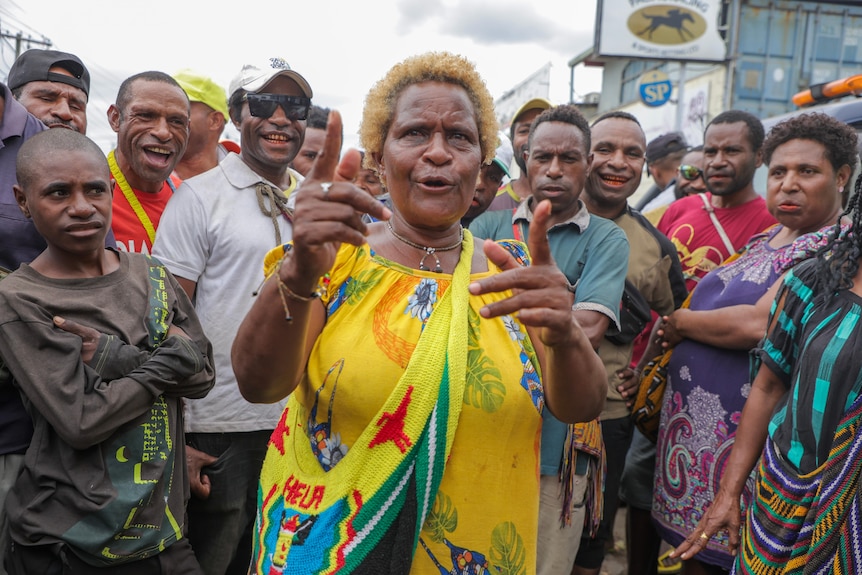 a woman wears yellow in a crowd