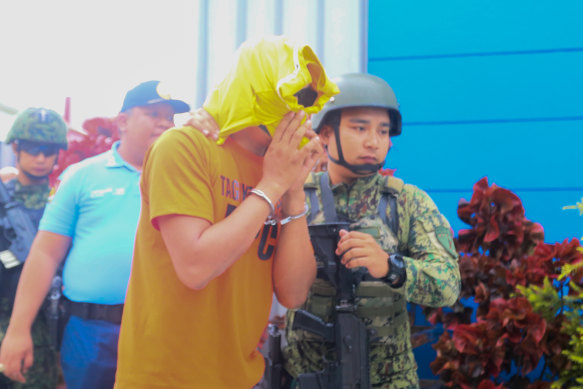 The suspect in the triple murder case being transferred to the Hall of Justice in Tagaytay City, Philippines, in July.