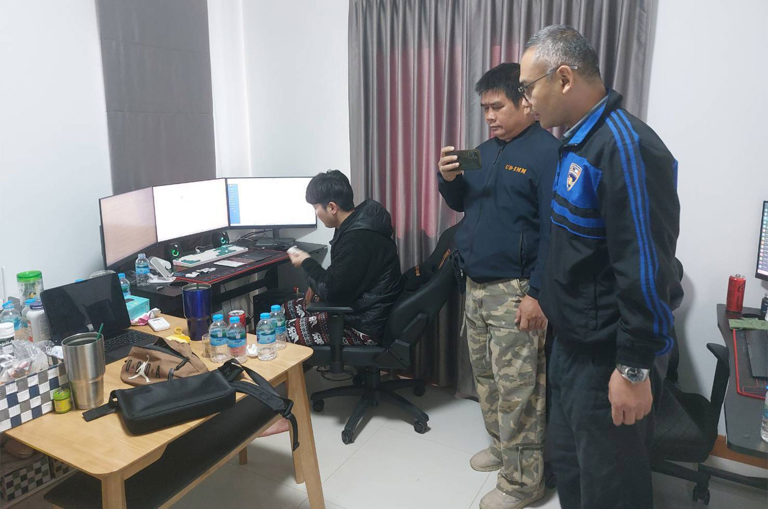 Another South Korean man is arrested during the raid on the rental house in Udon Thani. (Photo: Chakkrapan Natanri)