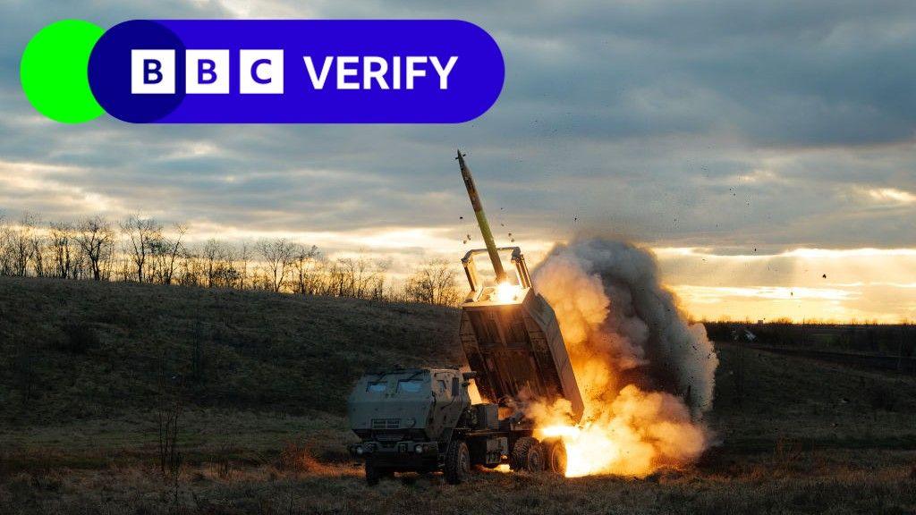 A Ukrainian team fires a US donated HIMARS at a Russian position. The rocket is being launched and fire can be seen coming out of it. 