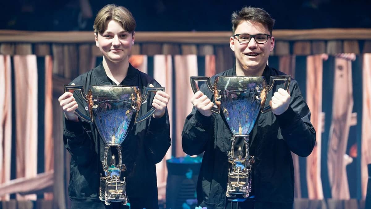 An image of Aqua and His duo holding up trophies after winning the Fortnite World Cup.