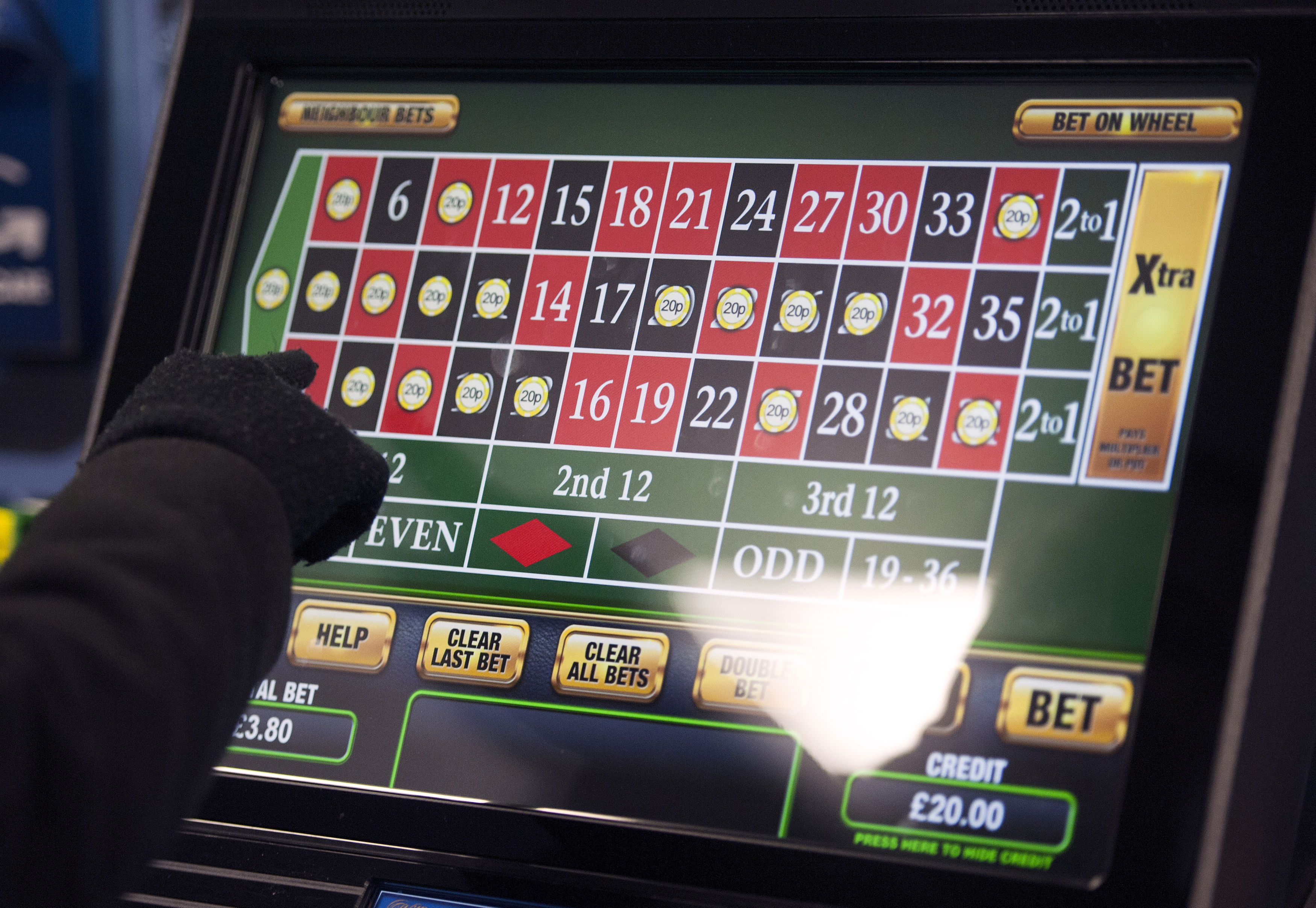 File photo dated 12/01/13 of a someone using a gambling machine. The maximum stake for fixed-odds betting terminals (FOBT) should be cut to ¿30 or less, the Gambling Commission has recommended. PRESS ASSOCIATION Photo. Issue date: Monday March 19, 2018. High-stake, high-speed electronic casino games are said to be dangerously addictive and currently allow a stake of up to ¿100 every 20 seconds, enabling a player to theoretically gamble away ¿18,000 an hour. See PA story POLITICS Gambling. Photo credit should read: Daniel Hambury/PA Wire