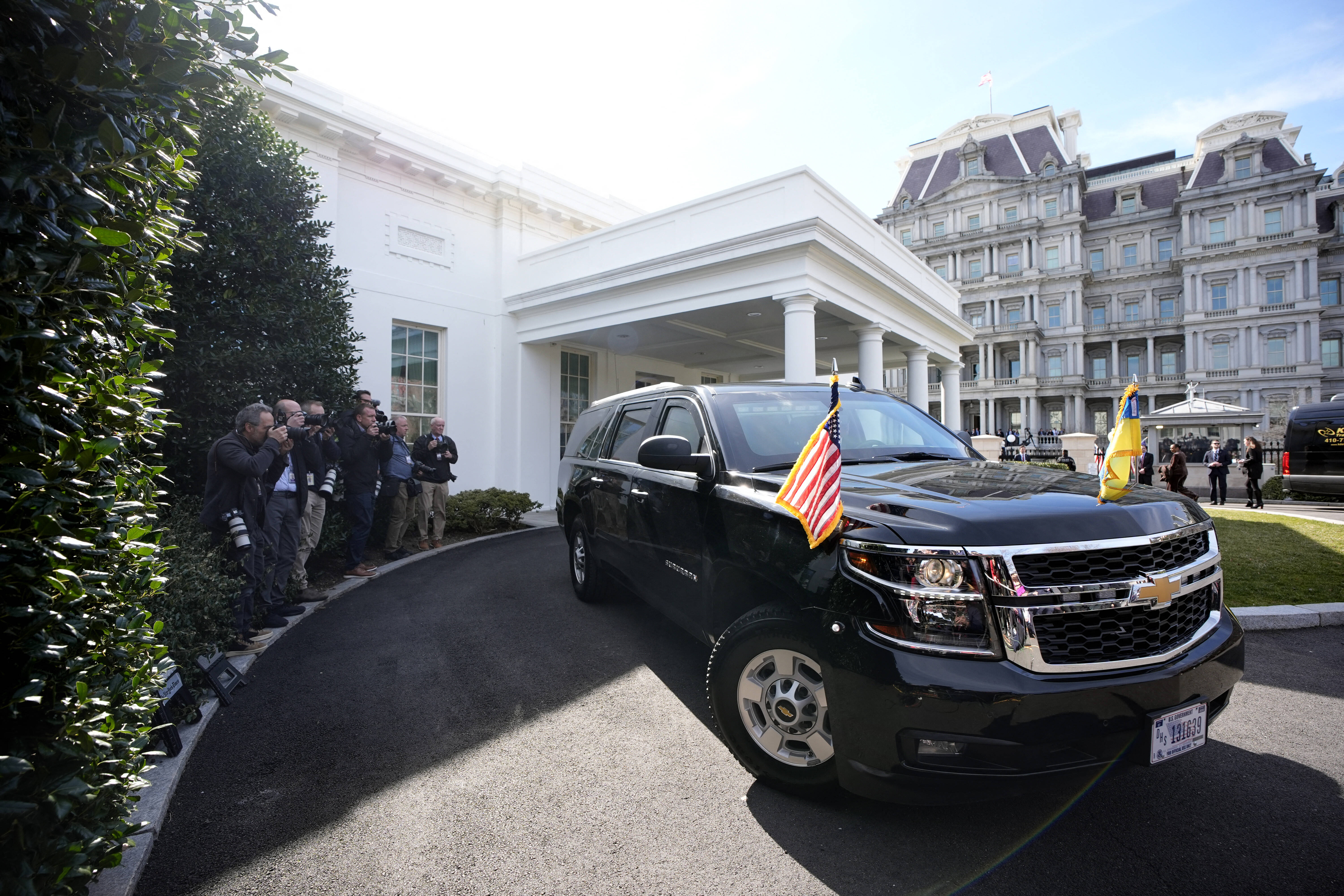 Volodymyr Zelensky departing the White House in a black SUV.